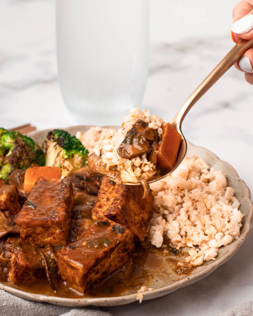 Vegan keto Japanese curry served with cauliflower fried rice and pan-fried tofu