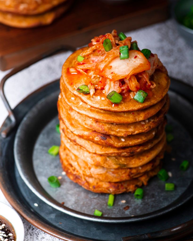 Crispy gluten-free vegan kimchi pancakes stacked on a plate
