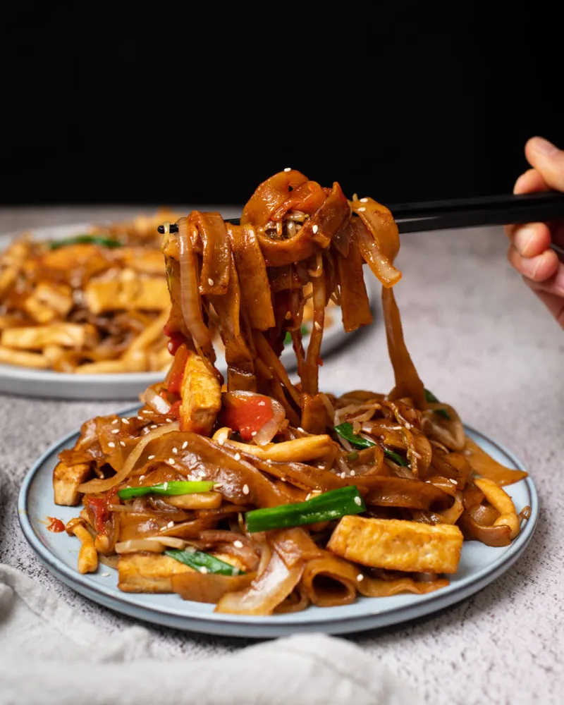 Hong Kong-style vegan chow fun with pan-fried tofu and mushrooms