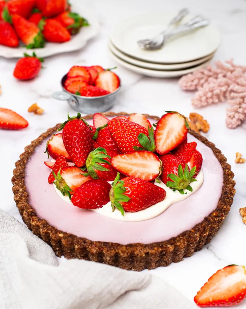 Keto vegan strawberry cream tart with fresh strawberries on top
