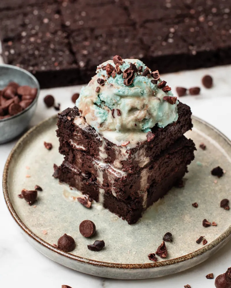 Fudgy vegan keto brownies topped with sea salt flakes and cacao nibs